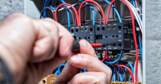 person working on an electrical panel