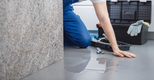 Plumber checking hidden leak inside the wall