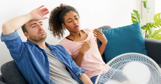 Stressed couple trying to refresh from hot weather