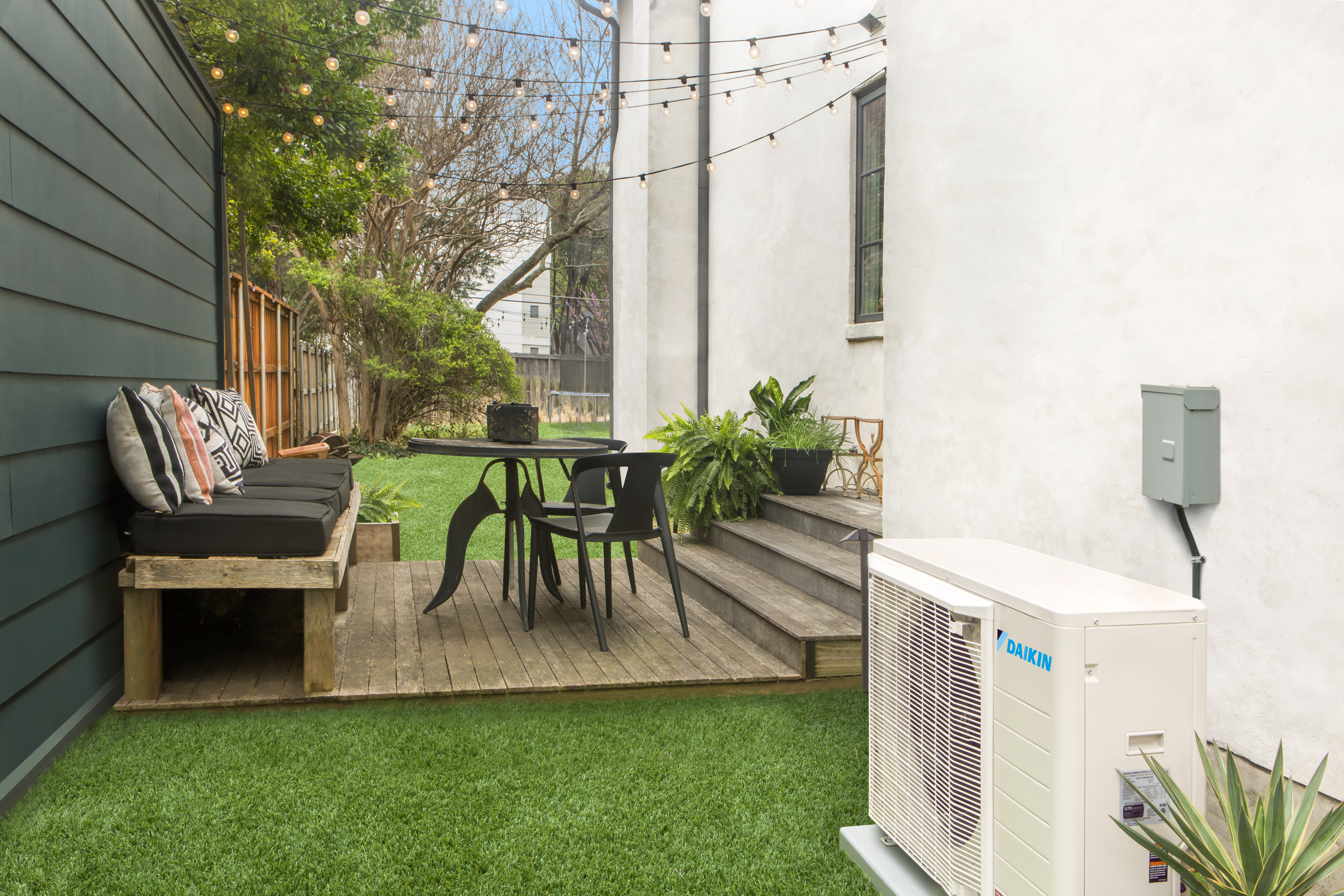 Andgar Home Comfort installs and repairs Daikin Fit outdoor units like this one alongside a home porch